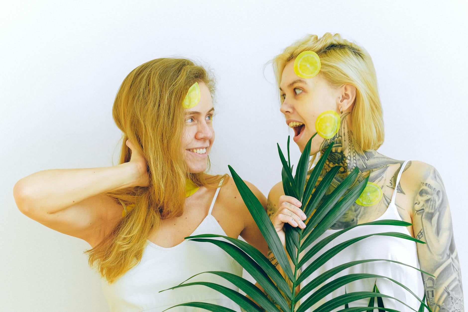 Two women laughing together, representing joy and comfort with sensuality