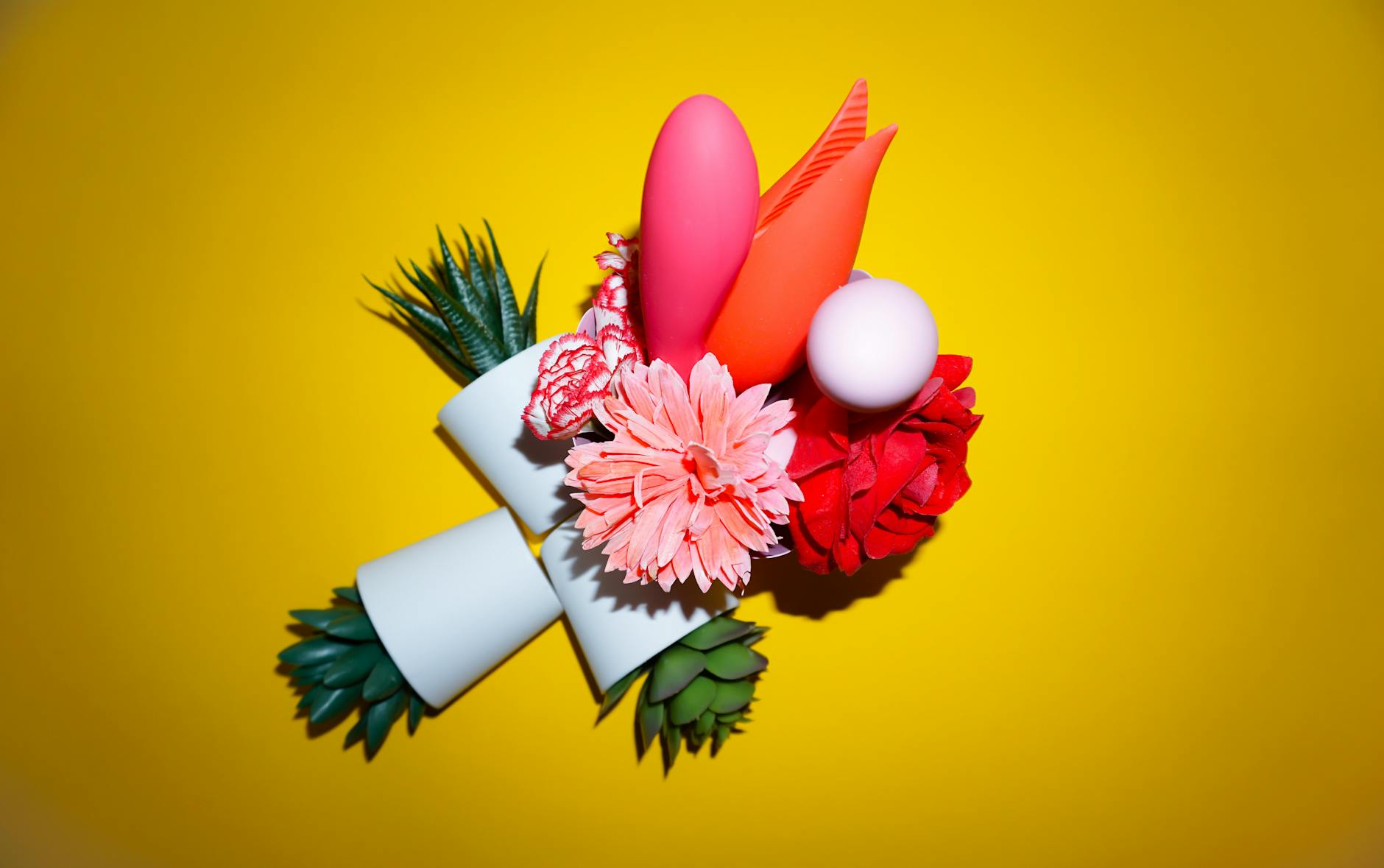 Woman holding colorful vibrators, representing couples exploration and intimate sharing